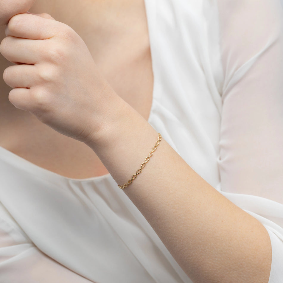 Zlatý elegantní náramek s neobvyklým vzorem pletení